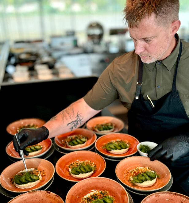 Chef Bryan Voltaggio plating up dishes to serve