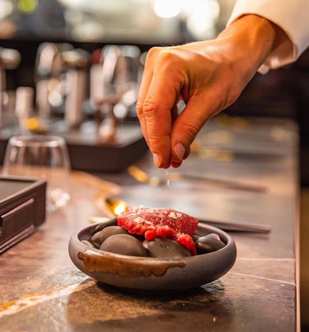 Hands sprinkling salt on food