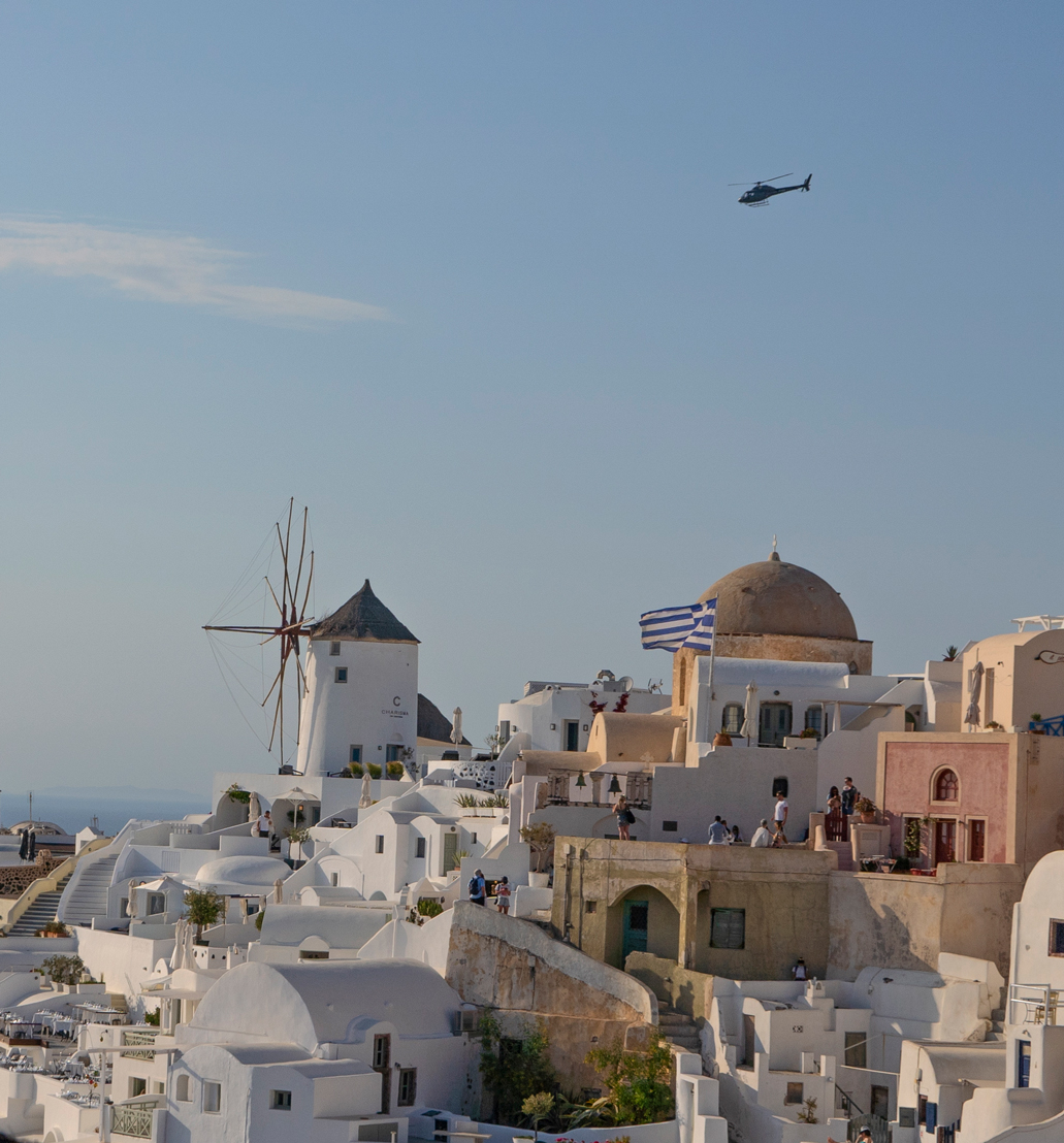 Helicopter flying over Santorini