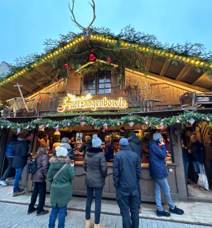 Customers queuing outside alpine looking christmas market stall